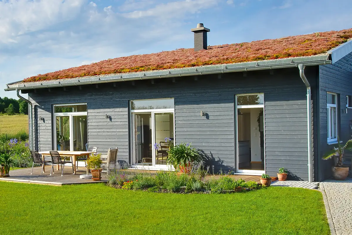 Querliegende graue Holzfassade an einem Pultdach-Bungalow